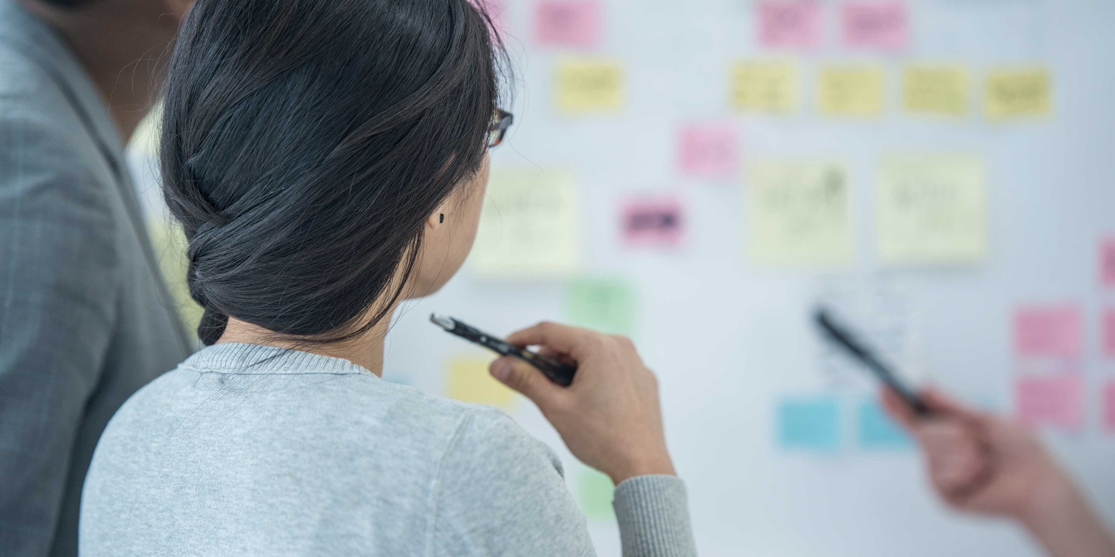 Team planning a project with whiteboard